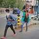 Ramesh Meena from Rajasthan carries his wife, who fractured her leg, on his shoulder, as they leave for their village from Ahmedabad.